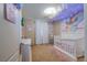 Whimsical bedroom with unicorn decor, rainbow wall art, and a crib at 9032 Retro Ct, Las Vegas, NV 89149