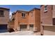 Exterior view of garages with tan doors and stucco walls in a residential community, offering parking at 9032 Retro Ct, Las Vegas, NV 89149