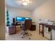 Functional home office space with built-in desk, dual monitors, and neutral decor at 9032 Retro Ct, Las Vegas, NV 89149