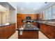 Bright kitchen features granite countertops, wooden cabinets, tile floors, and a center island at 9032 Retro Ct, Las Vegas, NV 89149