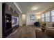 Inviting living room with sleek hardwood floors, modern entertainment center, and comfortable seating area at 9032 Retro Ct, Las Vegas, NV 89149