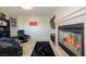 Cozy living room featuring a fireplace, plush seating, and a stylish black rug on top of tan carpet at 9032 Retro Ct, Las Vegas, NV 89149