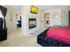 Relaxing primary bedroom featuring a fireplace, TV, and sitting area at 9032 Retro Ct, Las Vegas, NV 89149