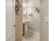 Stylish powder room featuring pedestal sink, decorative wall art, and neutral color scheme at 9032 Retro Ct, Las Vegas, NV 89149