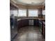 Modern kitchen featuring stainless steel appliances, dark cabinetry and granite countertops at 9145 Sunken Meadow Ave, Las Vegas, NV 89178