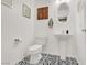 Stylish powder room featuring black and white patterned floors and a pedestal sink at 9869 Lime Tree St, Las Vegas, NV 89178