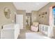 Bedroom with crib, changing table, chair and pink curtains at 9869 Lime Tree St, Las Vegas, NV 89178