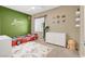 bedroom with vibrant green walls and a themed race car bed at 9869 Lime Tree St, Las Vegas, NV 89178