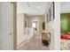 Hallway with neutral walls leading to bedrooms with decorative touches at 9869 Lime Tree St, Las Vegas, NV 89178