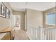 Upstairs hallway with white banister and views of a cozy sitting area at 9869 Lime Tree St, Las Vegas, NV 89178
