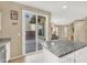 Open kitchen with granite countertops, stainless steel appliances, and a sliding glass door to the patio at 9869 Lime Tree St, Las Vegas, NV 89178