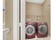 Functional laundry room with modern machines, built-in shelving, and ample storage space at 9869 Lime Tree St, Las Vegas, NV 89178