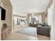 Open living space with tile flooring, neutral walls, and comfortable seating next to the kitchen at 9869 Lime Tree St, Las Vegas, NV 89178
