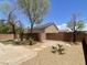 A view of the backyard showcasing mature trees and landscaping at 10052 Baystone St, Las Vegas, NV 89141