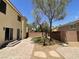 A well-maintained backyard with mature trees, plants and a patio at 10052 Baystone St, Las Vegas, NV 89141