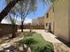An overview of the backyard, featuring mature trees and a patio area at 10052 Baystone St, Las Vegas, NV 89141