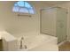 Bathroom with a large soaking tub and a glass-enclosed shower at 10052 Baystone St, Las Vegas, NV 89141