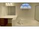 Bathroom featuring a vanity, soaking tub, and natural light at 10052 Baystone St, Las Vegas, NV 89141