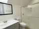 Clean bathroom features a single sink vanity with tub-shower combo and white tile surround at 10052 Baystone St, Las Vegas, NV 89141