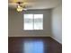 Bedroom with dark floors, a ceiling fan, and lots of natural light at 10052 Baystone St, Las Vegas, NV 89141