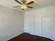 Bedroom featuring a ceiling fan, closet and wood flooring at 10052 Baystone St, Las Vegas, NV 89141