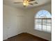 Bedroom features a ceiling fan, wood-look flooring, closet, and window with a view at 10052 Baystone St, Las Vegas, NV 89141