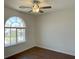 Bedroom with wood-look flooring, modern ceiling fan, and window for natural light at 10052 Baystone St, Las Vegas, NV 89141