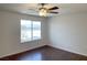 Bedroom featuring dark floors, neutral paint, a ceiling fan, and natural light at 10052 Baystone St, Las Vegas, NV 89141
