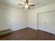 Bedroom features wood-look flooring, ceiling fan, and double closets for ample storage at 10052 Baystone St, Las Vegas, NV 89141