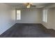 Comfortable bedroom with neutral carpet, ceiling fan, and bright windows at 10052 Baystone St, Las Vegas, NV 89141