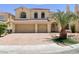 Charming two-story home with a well-maintained lawn, mature palm tree, and a two-car garage at 10052 Baystone St, Las Vegas, NV 89141