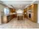 Spacious kitchen boasts wooden cabinets, granite countertops, stainless steel appliances, and a central island at 10052 Baystone St, Las Vegas, NV 89141