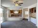 Open-concept living area with carpet flooring offering a view of the kitchen at 10052 Baystone St, Las Vegas, NV 89141