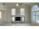 Bright living room with a fireplace, large windows, and sleek marble flooring at 10052 Baystone St, Las Vegas, NV 89141