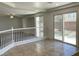Bright living room with tile flooring leading to sliding glass doors and an open staircase at 10052 Baystone St, Las Vegas, NV 89141