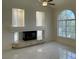 Bright living room with a fireplace, large windows, and sleek marble flooring at 10052 Baystone St, Las Vegas, NV 89141