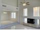 Spacious living area with fireplace, high ceilings, and elegant marble flooring at 10052 Baystone St, Las Vegas, NV 89141