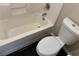 Bathtub and toilet combination with dark wood flooring at 10118 Farmington Hall Ct, Las Vegas, NV 89129