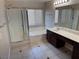 Bright bathroom featuring a shower, soaking tub and double sink vanity with dark wood cabinets at 10118 Farmington Hall Ct, Las Vegas, NV 89129