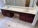 Bright bathroom features a double sink vanity with a white countertop and dark wood cabinets at 10118 Farmington Hall Ct, Las Vegas, NV 89129