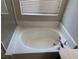 A close up shot of the bathtub with tile surround and chrome faucet at 10118 Farmington Hall Ct, Las Vegas, NV 89129