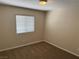 Cozy bedroom with neutral walls, carpet flooring and a window at 10118 Farmington Hall Ct, Las Vegas, NV 89129