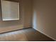 Bright bedroom featuring neutral carpeting and a large window for natural light at 10118 Farmington Hall Ct, Las Vegas, NV 89129