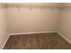 Walk-in closet with neutral carpet and rod with shelving at 10118 Farmington Hall Ct, Las Vegas, NV 89129