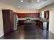 Open kitchen with cherry cabinets, stainless appliances, and an island at 10118 Farmington Hall Ct, Las Vegas, NV 89129