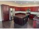 Stylish kitchen with a large island, stainless appliances, and hardwood floors at 10118 Farmington Hall Ct, Las Vegas, NV 89129
