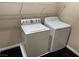 Convenient laundry room features a washer, dryer, and upper shelving for organized storage solutions at 10118 Farmington Hall Ct, Las Vegas, NV 89129