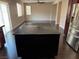 Living room with view of kitchen island, stainless steel refrigerator and open layout at 10118 Farmington Hall Ct, Las Vegas, NV 89129