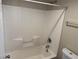 Shower and bathtub combination with white tile surround at 10118 Farmington Hall Ct, Las Vegas, NV 89129