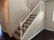 Carpeted staircase with white wooden banister and landing, leading to the upper level at 10118 Farmington Hall Ct, Las Vegas, NV 89129